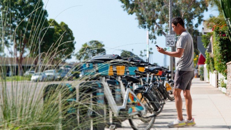 man next to bike stand